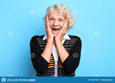 Excited Surprised Old Lady Touching Her Cheeks Looking At The Camera