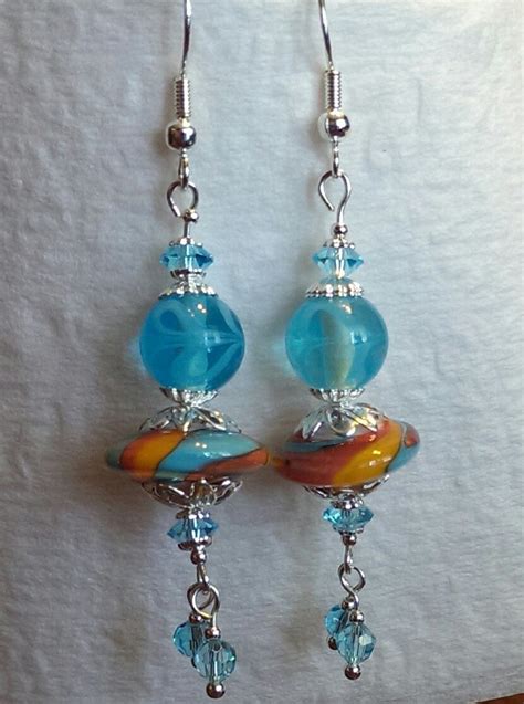 To learn how to make unique bead jewelry is not difficult. Home made earrings, glass multy colored flat bead and ...