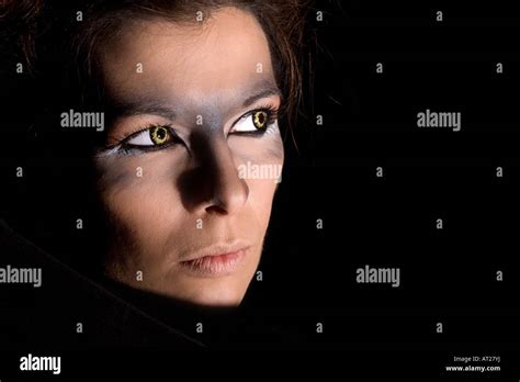 Beautiful Woman With Wolf Eyes Looking Out Of The Dak Stock Photo Alamy