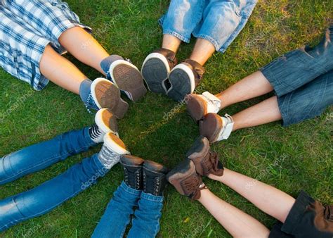 Teenage Friends Forming Circle With Their Legs Stock Photo Prudkov