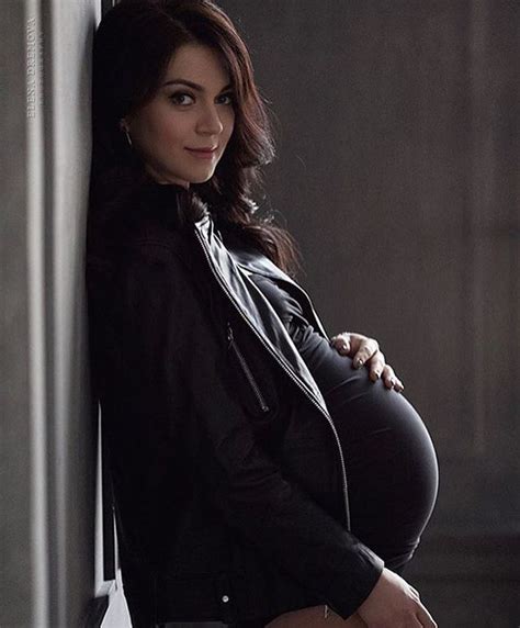 A Pregnant Woman Leaning Against A Wall