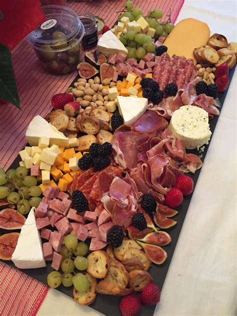 A Deluxe Charcuterie Platter With A Variety Of Meats Cheeses And Fruit