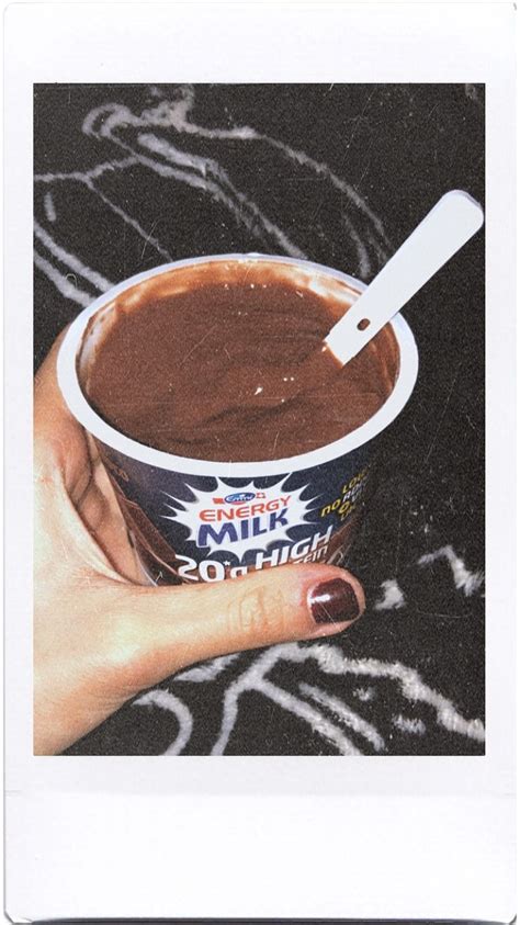 A Hand Holding A Cup Of Chocolate Ice Cream