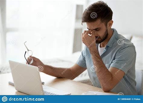 Stressed Fatigued Young Man Taking Off Glasses Feeling Eyestrain