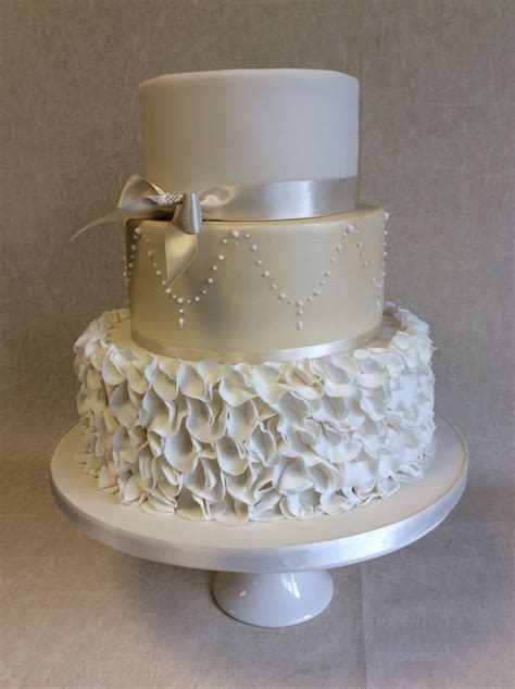 Ruffles 3 Tier Wedding Cake With Ruffle Bottom Tier And Champagne