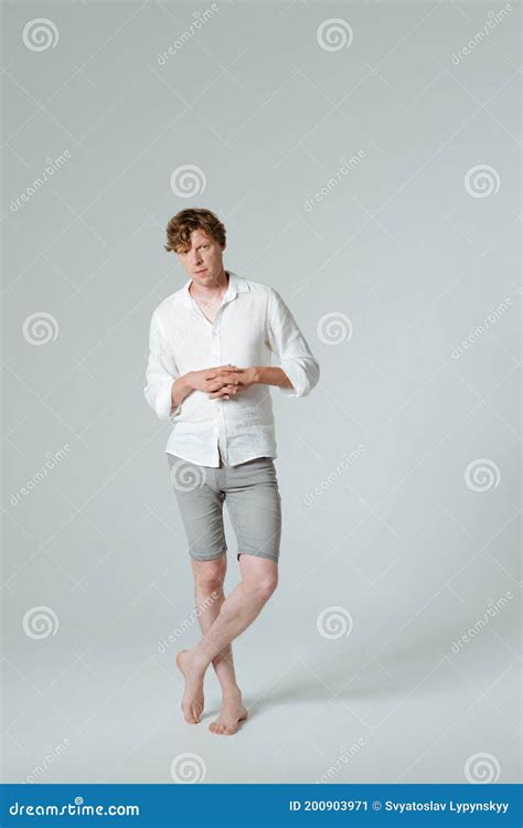 Pensive Man Standing Full Length Folded Arms And Crossed Legs Thinking