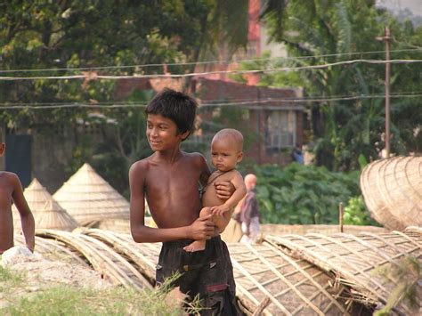 Bangladesh Brother With Tiny Sister At Rice Drying Area Photo By
