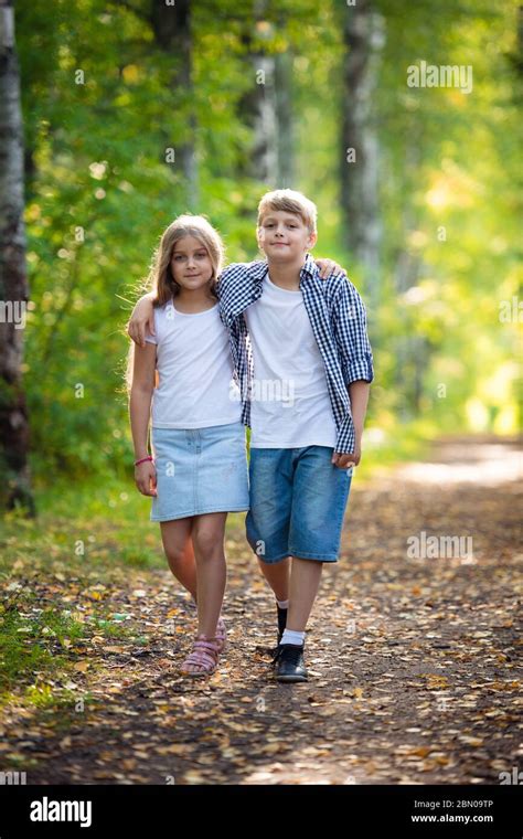 First Love Little Boy And Girl Holding Hands And Smiling While Walking