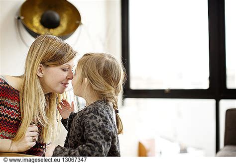 Mother And Daughter Rubbing Nose In Home Mother And Daughter Rubbing