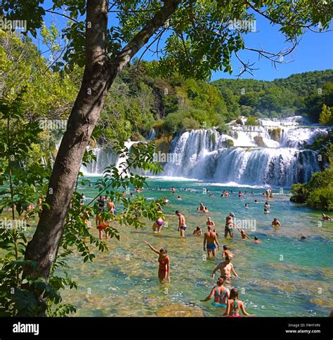 Krkacroatia Tourists Enjoy A Bath At Krka Waterfalls Beautiful