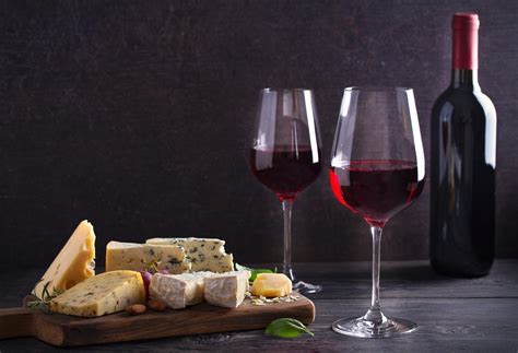 Red Wine With Cheese On Chopping Board Wine And Food Concept