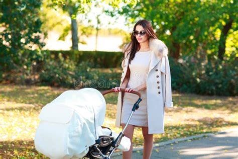 Mom Enjoys A Walk In The Park With A Stroller Stock Image Image Of