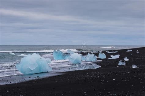 Amazing Transparent Blue Iceberg Pieces On Diamond Beach With Black