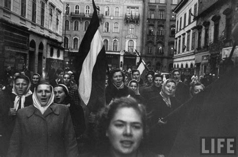 historic photos of hungarians gathered in the streets during revolution against soviet backed