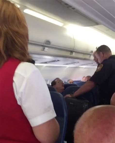 phone footage shows dramatic moment delta passenger dragged off plane by security after overhead