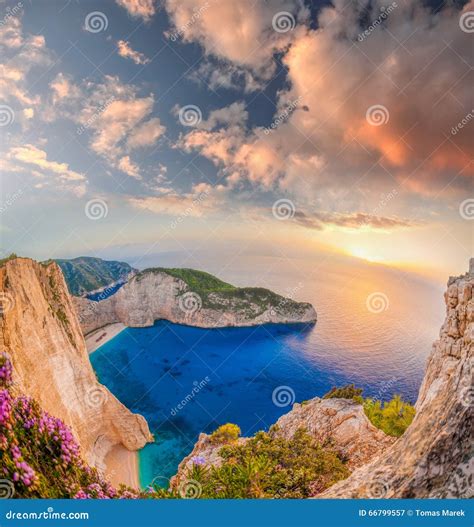 Navagio Beach With Shipwreck And Flowers Against Sunset On Zakynthos