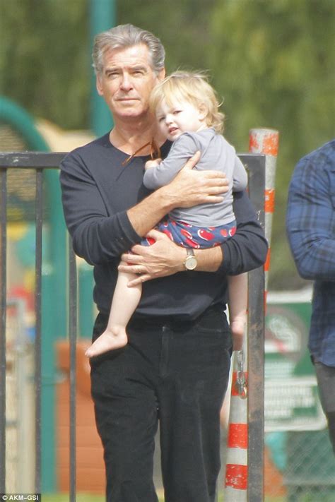 Do you like this video? Pierce Brosnan cradles his granddaughter on family walk ...