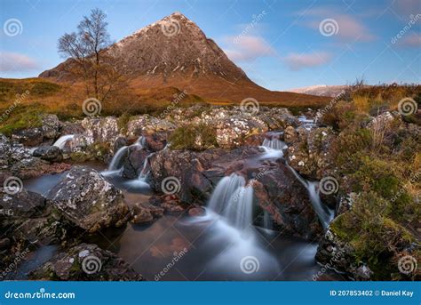 Beautiful Scotland Waterfall With Blue Sky And Snowcapped Mountain