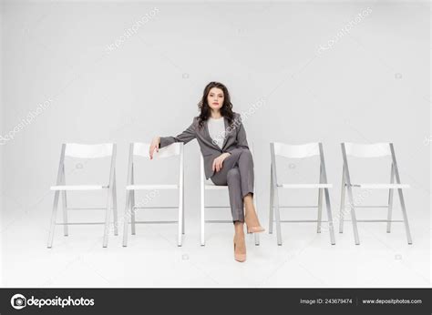 Attractive Woman Sitting Crossed Legs Chair Isolated Grey Stock Photo