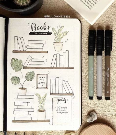 An Open Notebook With Books And Plants On It Next To Some Pens Scissors And Other Items