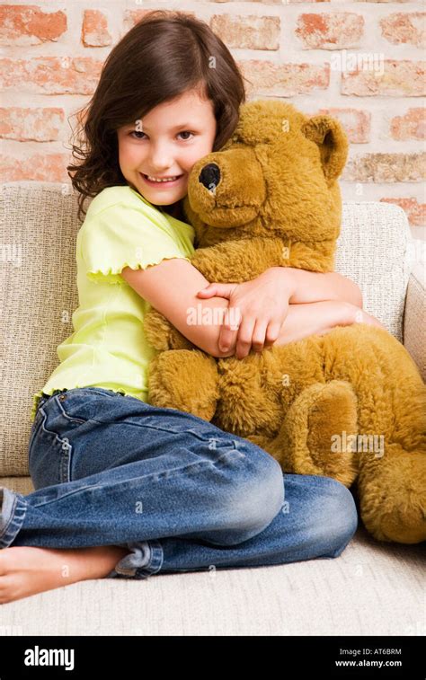 Girl 8 9 Hugging Teddy Bear Portrait Stock Photo Alamy