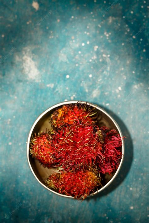 premium photo exotic hairy fruit rambutan in rustic style