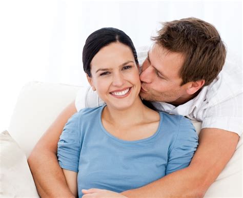 Premium Photo Lovely Man Kissing His Girlfriend While Relaxing On The Sofa