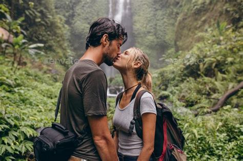 Loving Young Couple Kissing While Standing In The Forest