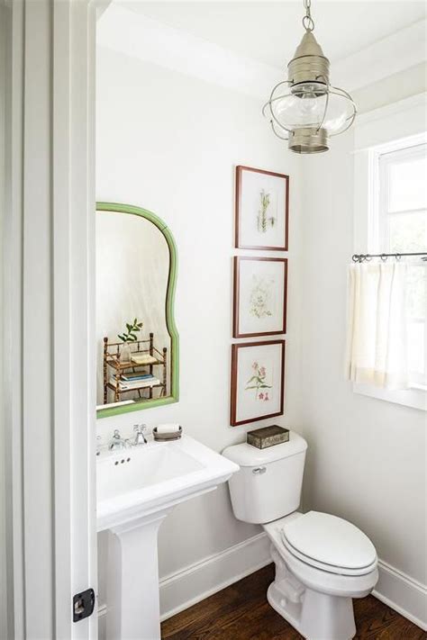 Country Powder Room Features White Walls Lined With A Green Mirror Over