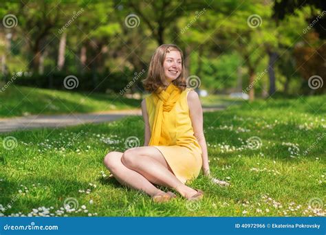 Girl In Yellow Dress Sitting On The Grass Stock Photo Image 40972966