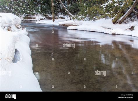 Snow And Ice Covered Creek In Winter Stock Photo Alamy