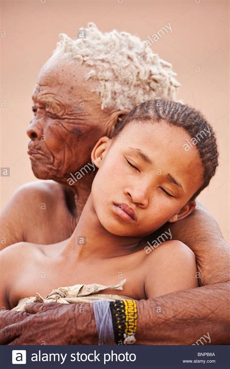 One of the most physically attractive features of a woman is her curves. Bushman/San People. Young girl with old woman embracing ...