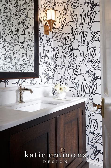 Fun Bathroom Design Featuring Gold Accents And Patterned Wallpaper