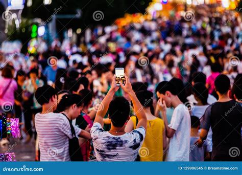 People Taking Photos Of Crowds With Mobile Phone Editorial Image