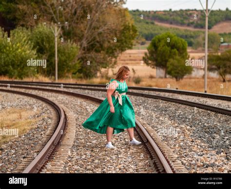 Woman Sitting On Railroad Tracks High Resolution Stock Photography And