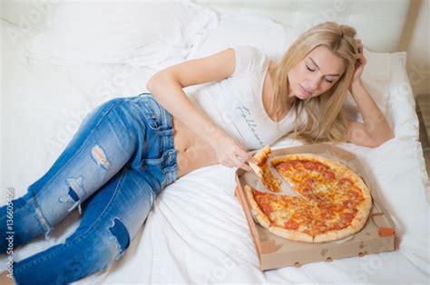 Beautiful Girl Eating Pizza Cheerful Blond Woman Sitting On A Bed Very Beautiful Russian Girl