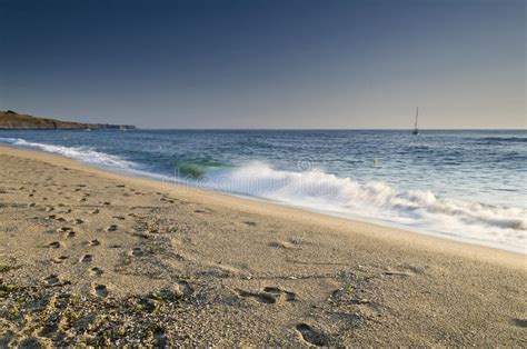 Splashing Waves At Sandy Beach During Beauty Sunset Stock Photo Image