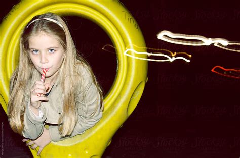 Seven Year Blonde Girl With Lollipop On Playground By Marija Anicic