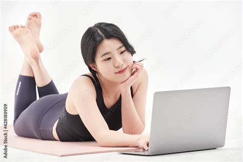 Asia Korean Girl Long Haired Beautiful Pilates Or Yoga Athlete Does A Graceful Pose While