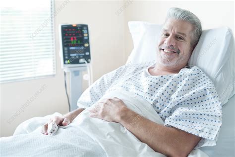 Mature Male Patient In Hospital Bed Smiling Stock Image F0205529