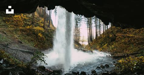 A Waterfall Is Coming Out Of A Cave Photo Free Or Image On Unsplash