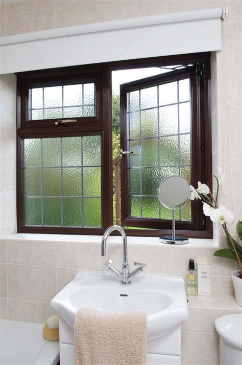 A Upvc Window In Dark Woodgrain With Obscure Glass For Added Privacy