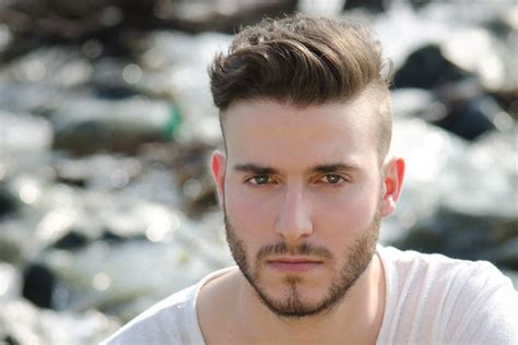 This is a light blonde pixie cut with a side part and volume. Men's Hair Trend: Short Sides, Disconnected Top