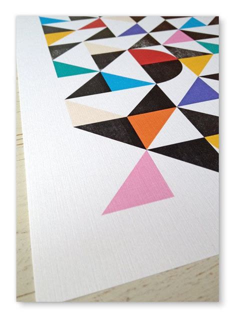 An Art Print With Different Colored Shapes On White Paper Next To A