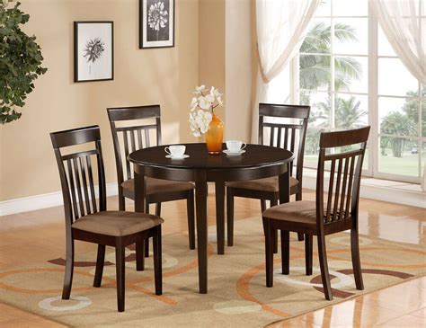 A table and four chairs feature solid wooden constructions. 5-PC SET ROUND DINETTE KITCHEN TABLE & 4 MICROFIBER ...