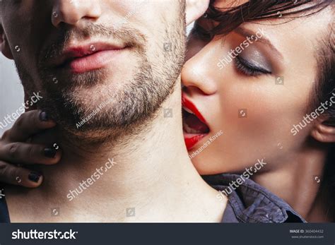Woman Kissing A Man On The Neck Stock Photo Shutterstock
