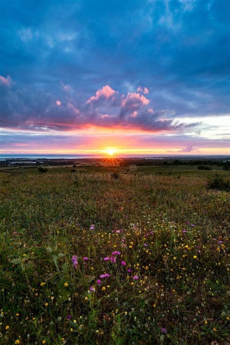 Sunset On The Horizon With Sky Over A Rural Field And The Sea In The