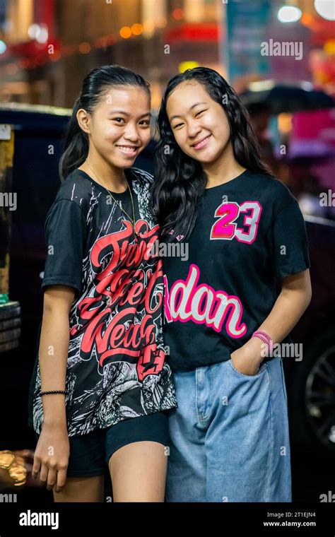 Two Young Pretty Filipino Girls Pose And Smile For Their Portrait In