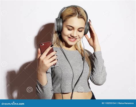 Beautiful Blond Woman In Headphones Listening To Music On White Stock