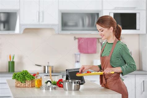 Young Woman Cooking In Kitchen Stock Photo By ©belchonock 101633986
